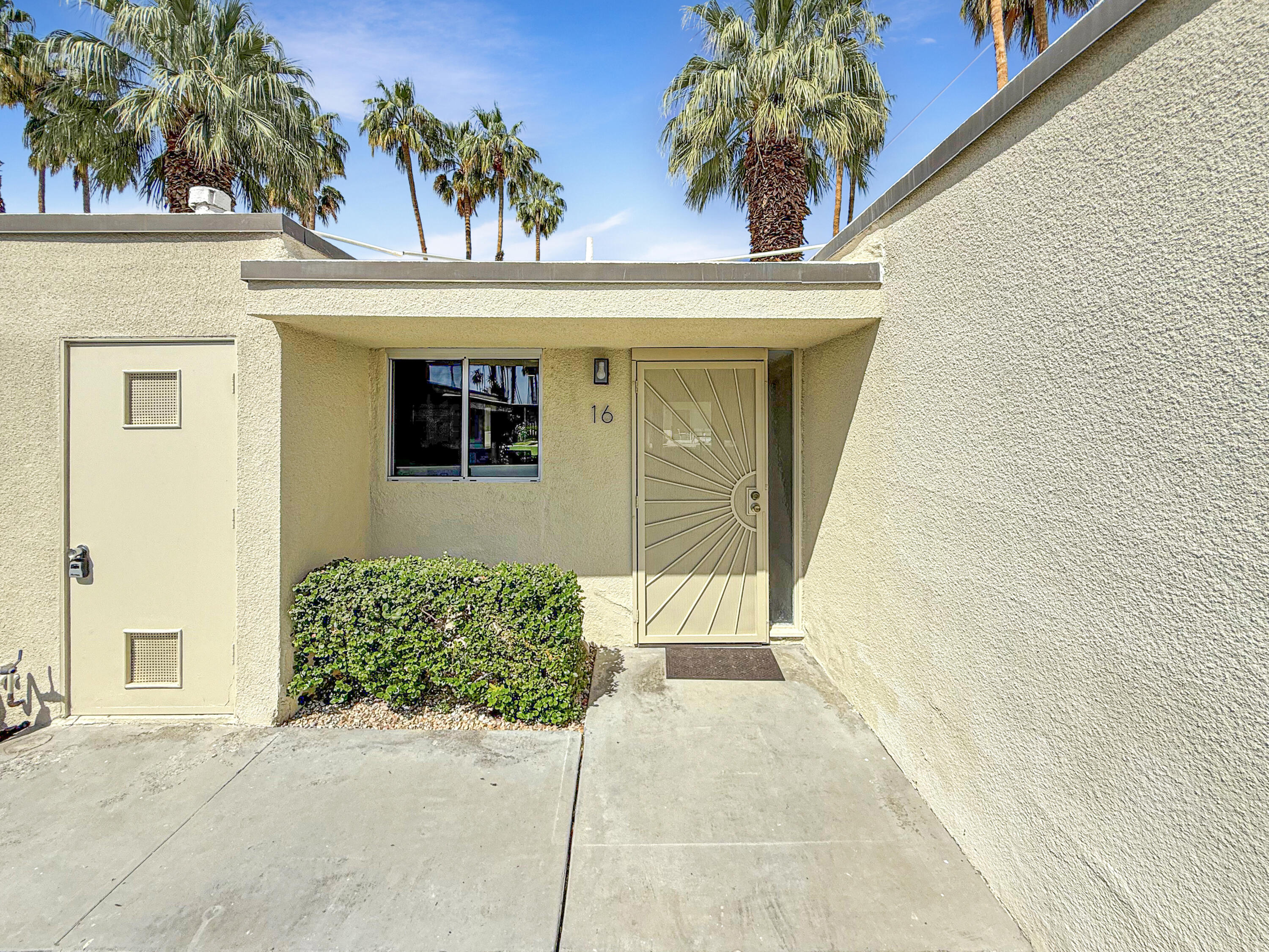 1881 South Araby Drive, Unit 16 Palm Springs, CA 92264 - Photo 31 of 52 a front view of a house with a garage