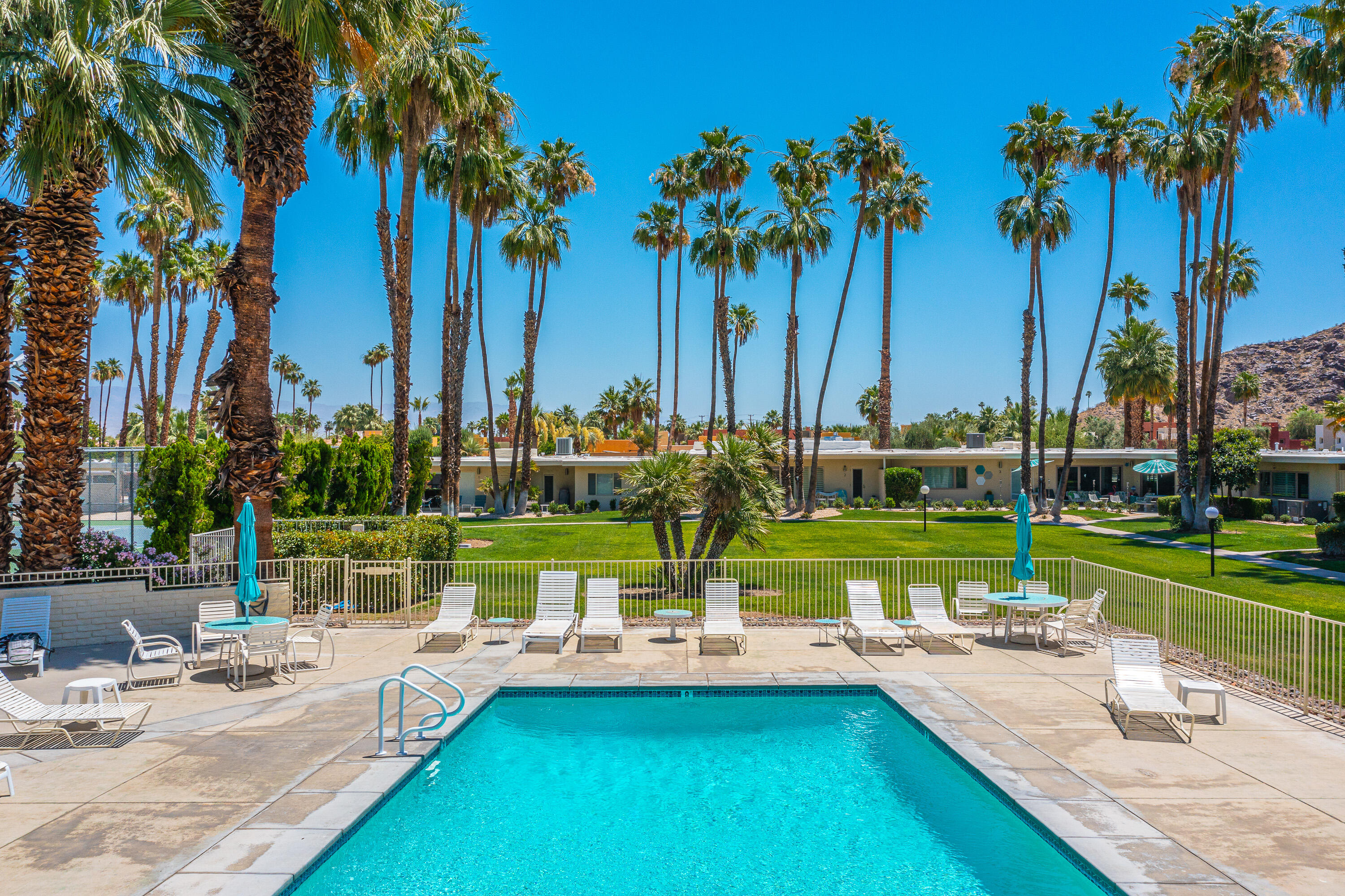 1881 South Araby Drive, Unit 16 Palm Springs, CA 92264 - Photo 46 of 52 a view of swimming pool with a table and chairs