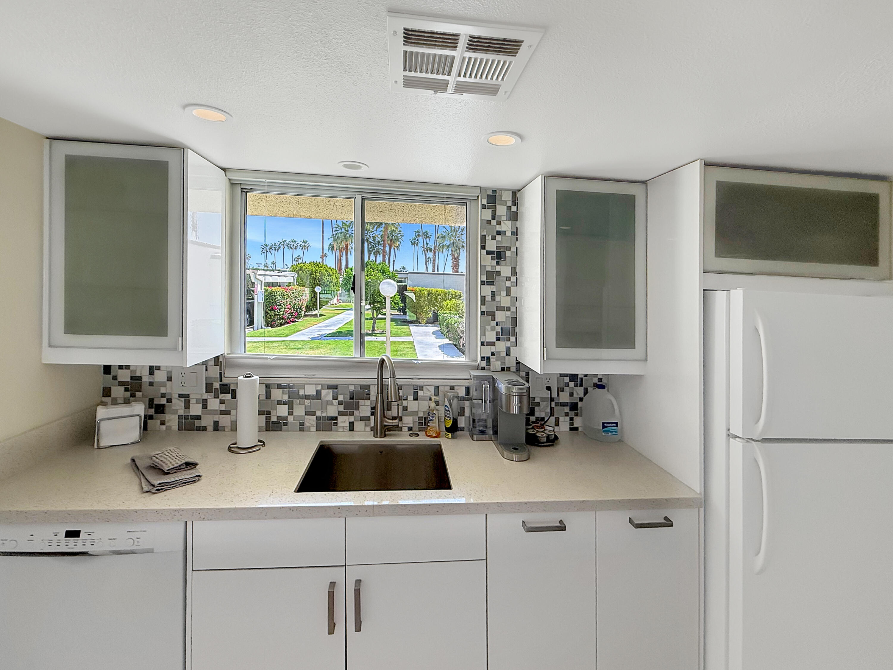 1881 South Araby Drive, Unit 16 Palm Springs, CA 92264 - Photo 5 of 52 a kitchen with a sink and a refrigerator