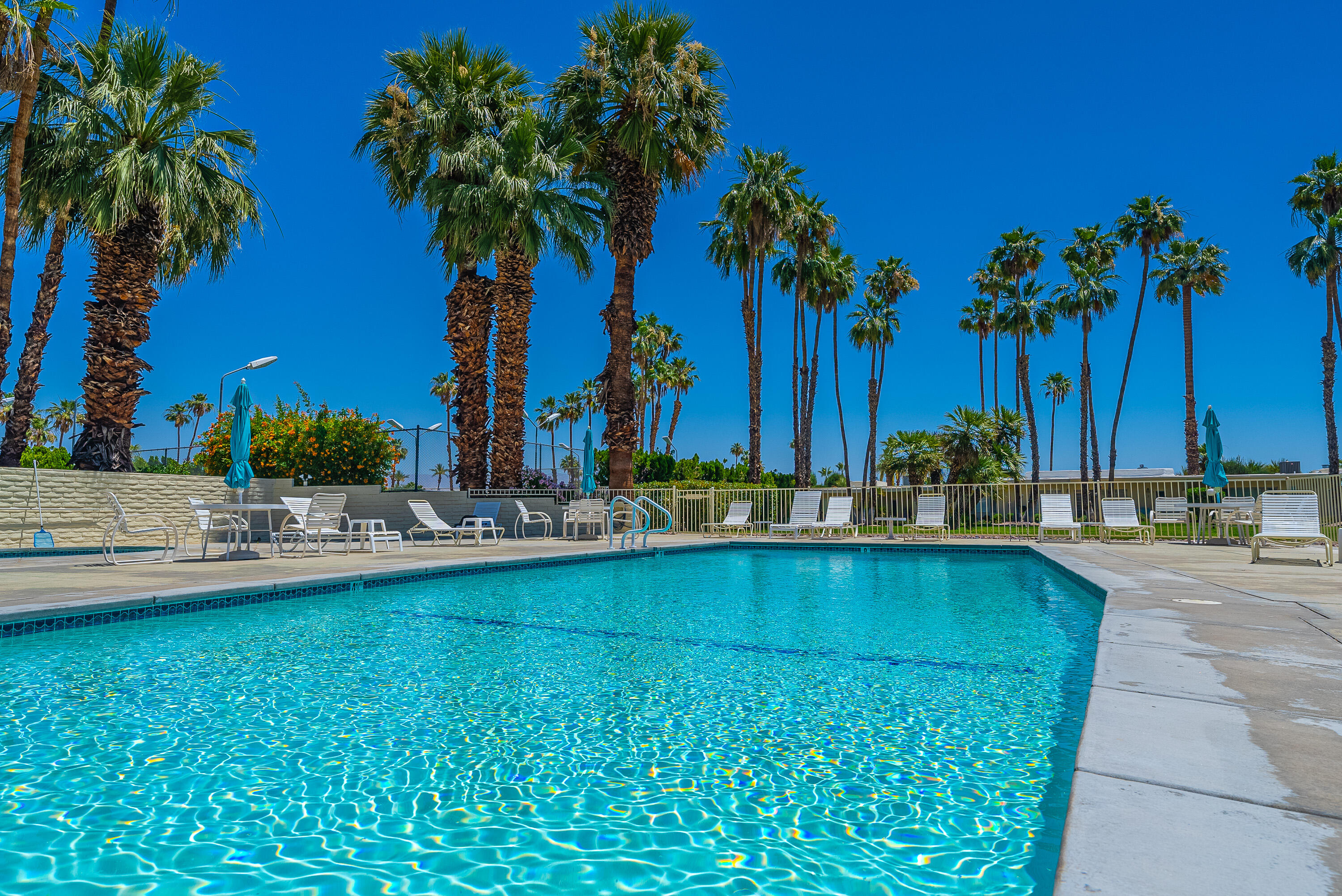 1881 South Araby Drive, Unit 16 Palm Springs, CA 92264 - Photo 51 of 52 a view of swimming pool with a table and chairs