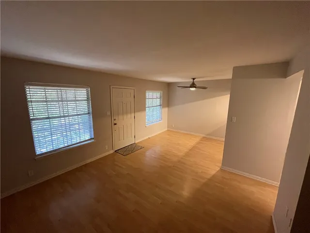 an empty room with windows and closet