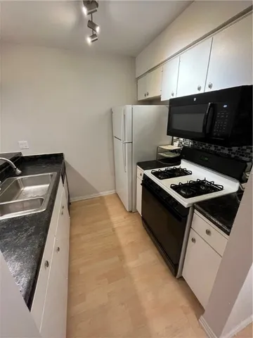 a kitchen that has a sink and a stove