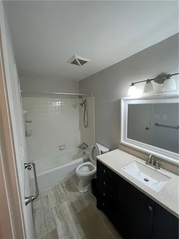 a bathroom with a double vanity sink toilet mirror and shower