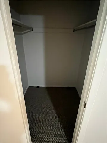 a view of a hallway with wooden floor and entryway