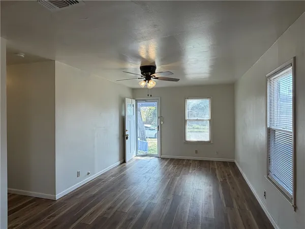 wooden floor in an empty room with a window