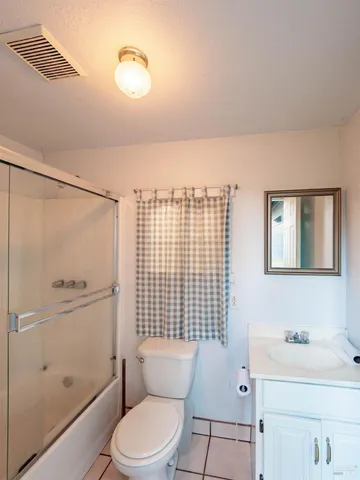 a bathroom with a toilet a sink and shower