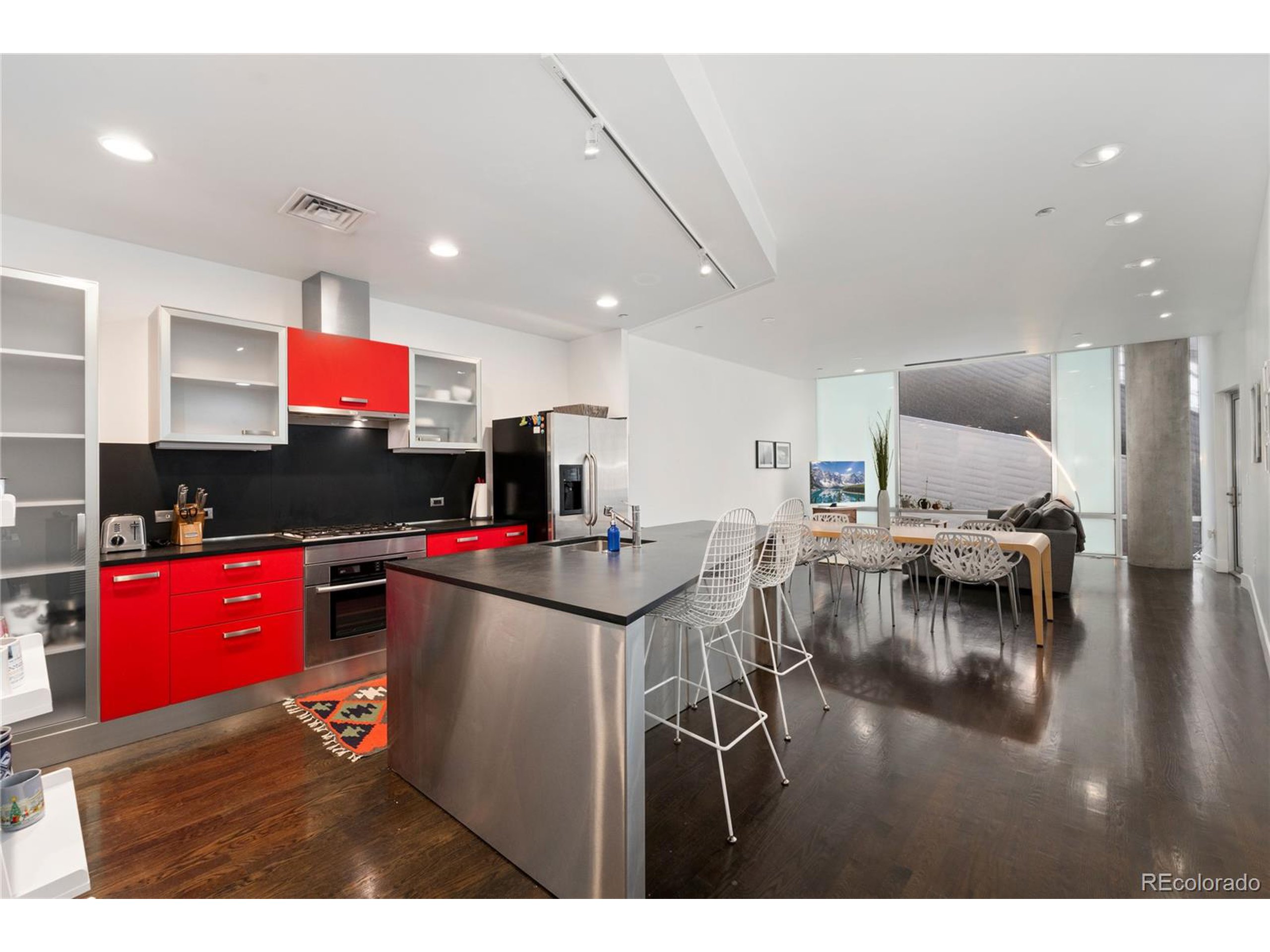 a kitchen with stainless steel appliances granite countertop a living room and living room view