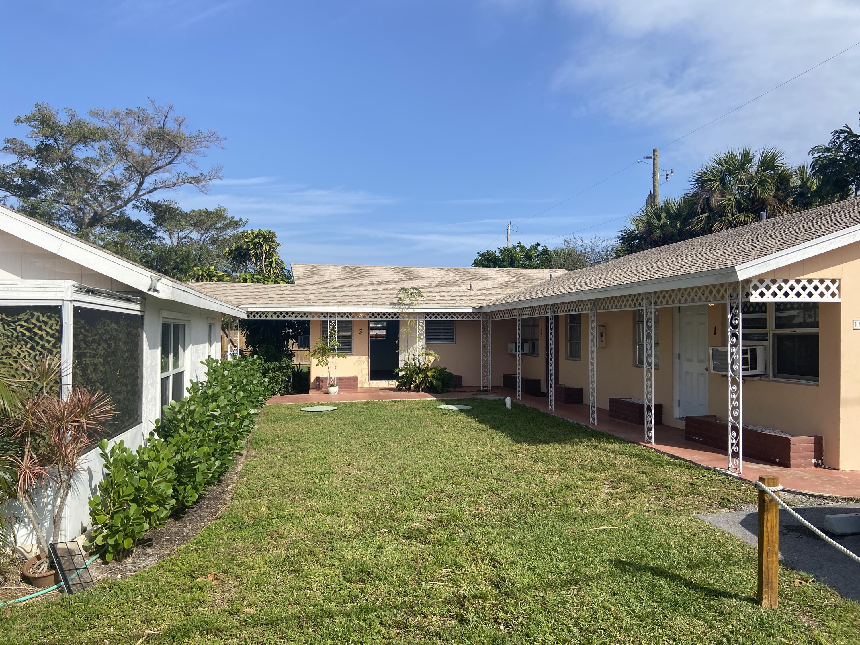 1815 Juno Road, Unit 3 North Palm Beach, FL 33408 - Photo 2 of 15 a view of a house with backyard porch and furniture