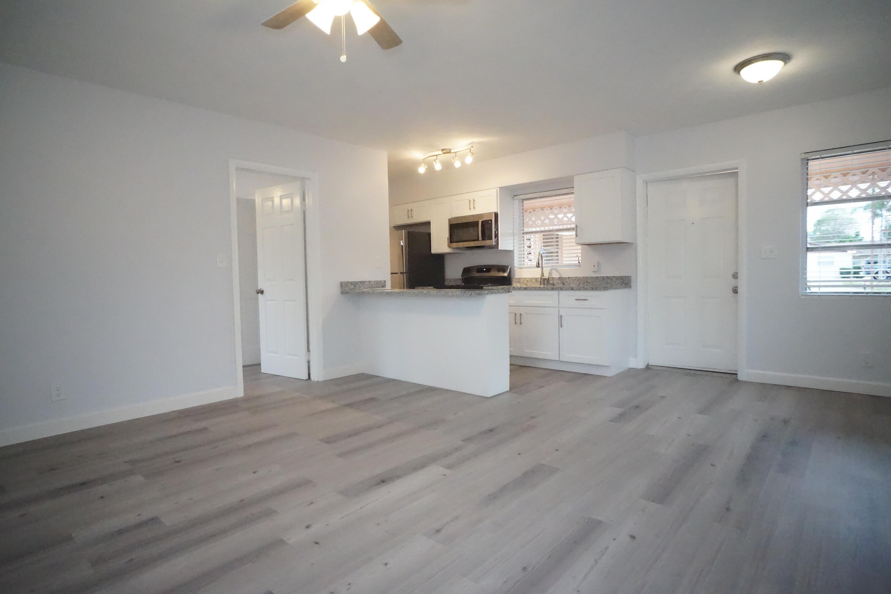 1815 Juno Road, Unit 3 North Palm Beach, FL 33408 - Photo 9 of 15 a view of a kitchen with microwave and cabinets