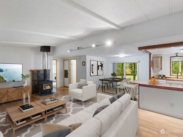 a living room with furniture a flat screen tv and a large window