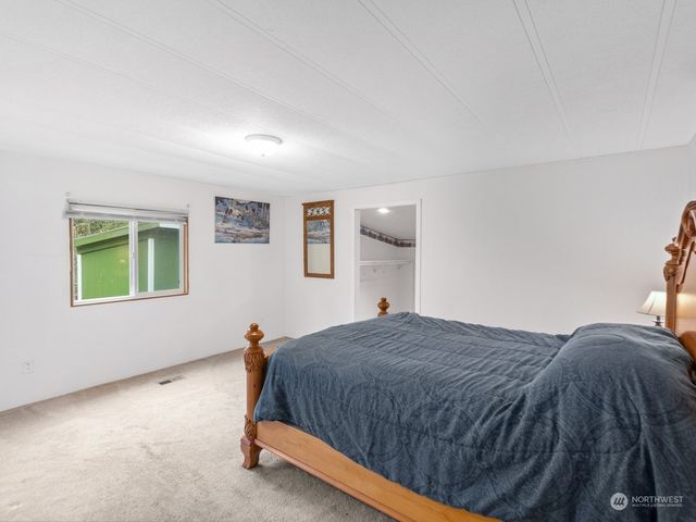 a spacious bedroom with a bed and a window