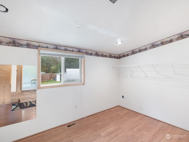 a view of a room with window and hardwood floor