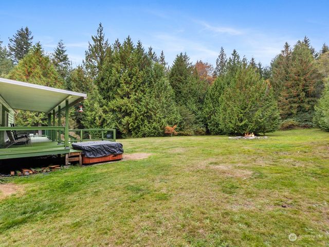 a view of a swimming pool with lawn chairs under an umbrella