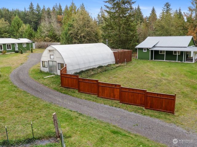 a view of a house with a yard balcony and mountain view