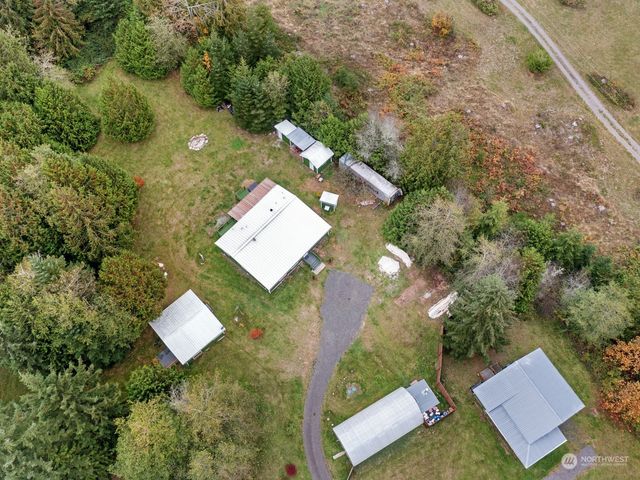 an aerial view of a house with yard