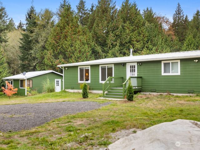 a view of a house with a yard and sitting area