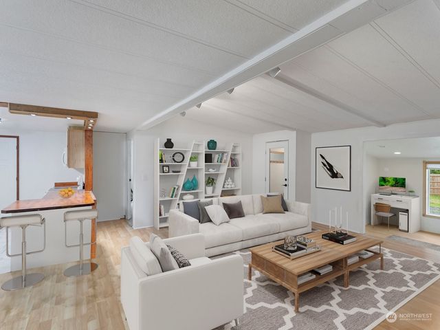 a living room with furniture a rug and a window