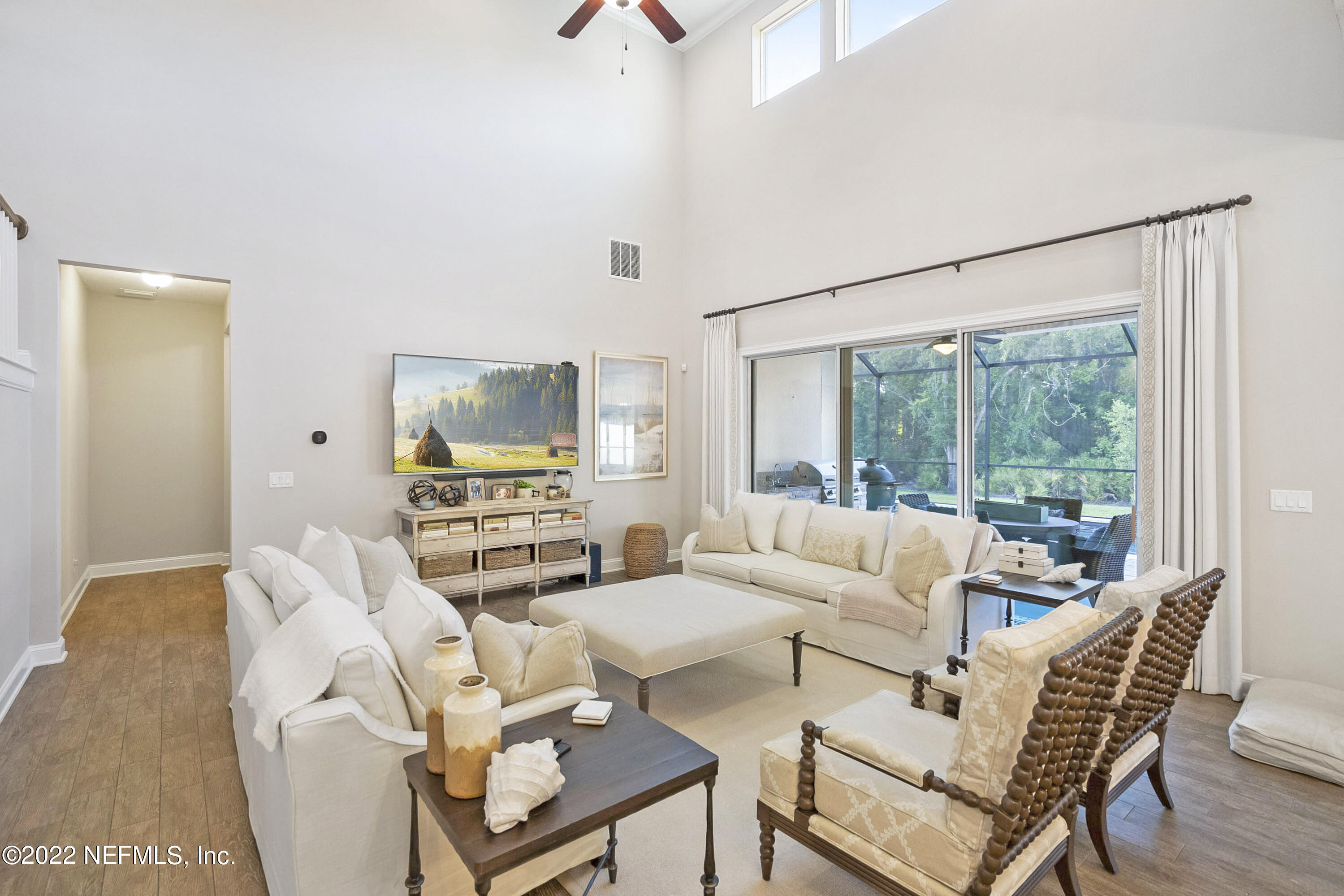 126 Broadleaf Lane St. Johns, FL 32259 - Photo 20 of 70 a living room with furniture a flat screen tv and a large window
