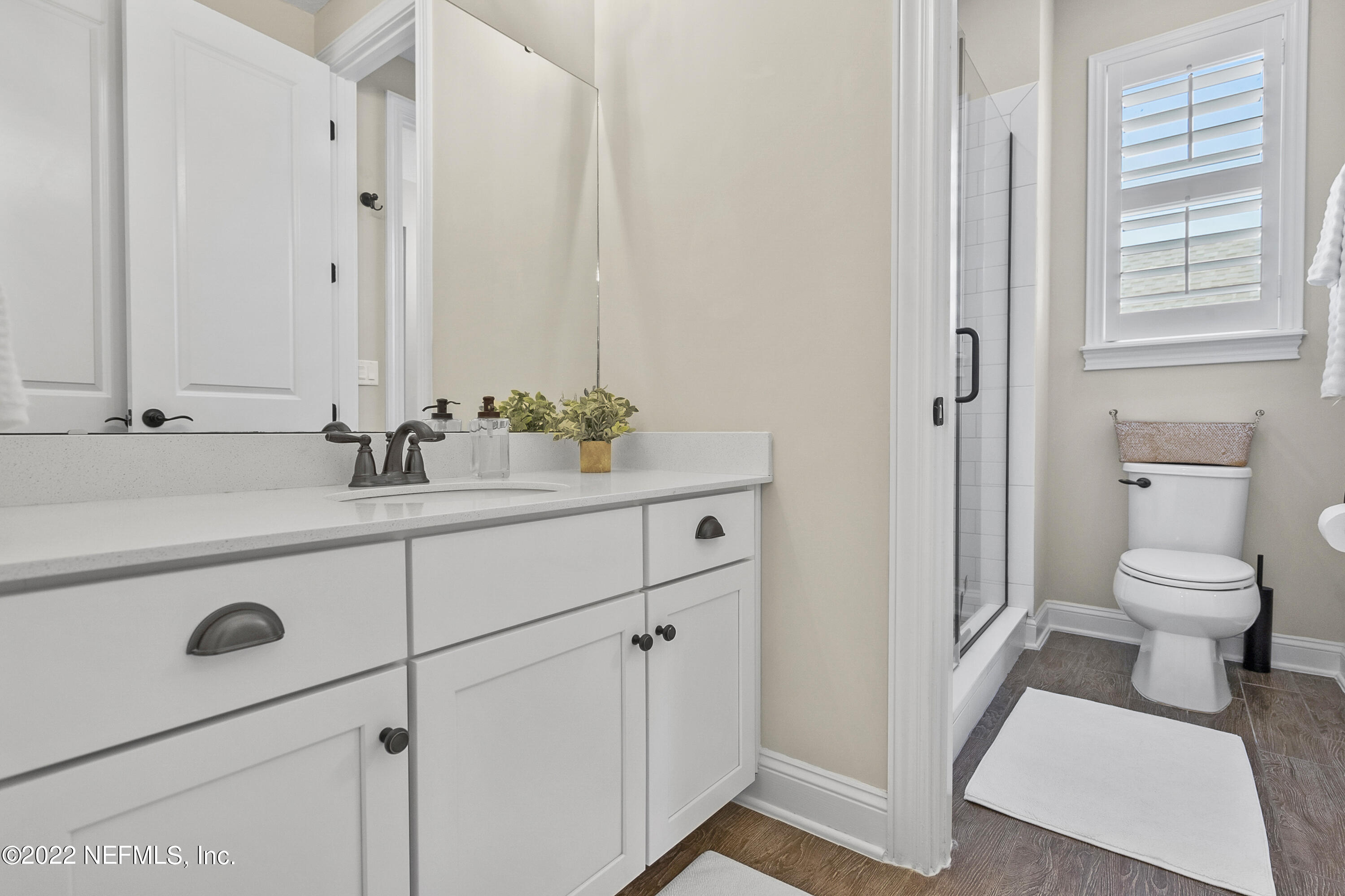 126 Broadleaf Lane St. Johns, FL 32259 - Photo 41 of 70 a bathroom with a sink a toilet and a mirror