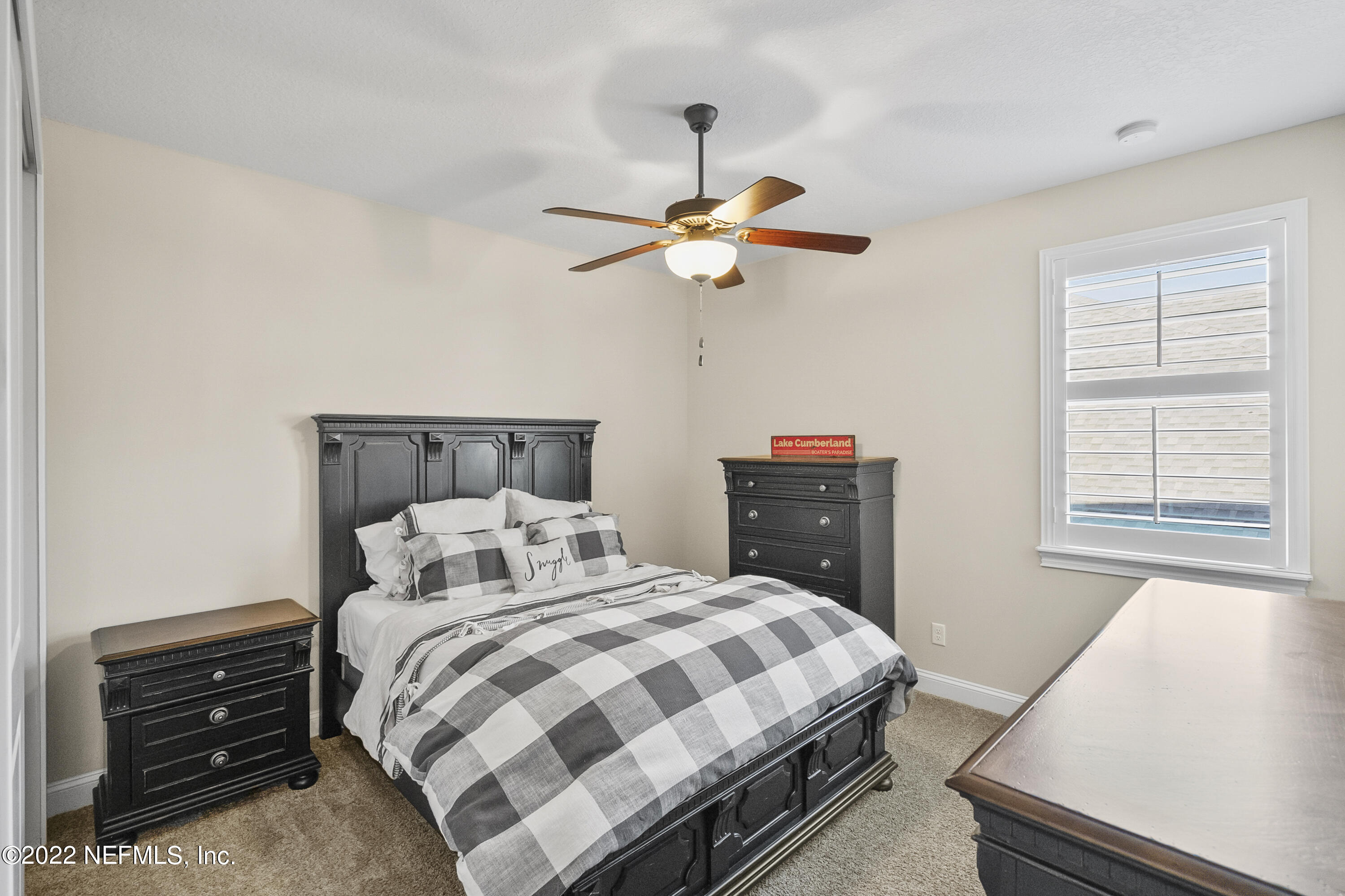 126 Broadleaf Lane St. Johns, FL 32259 - Photo 42 of 70 a bedroom with a bed and a chandelier