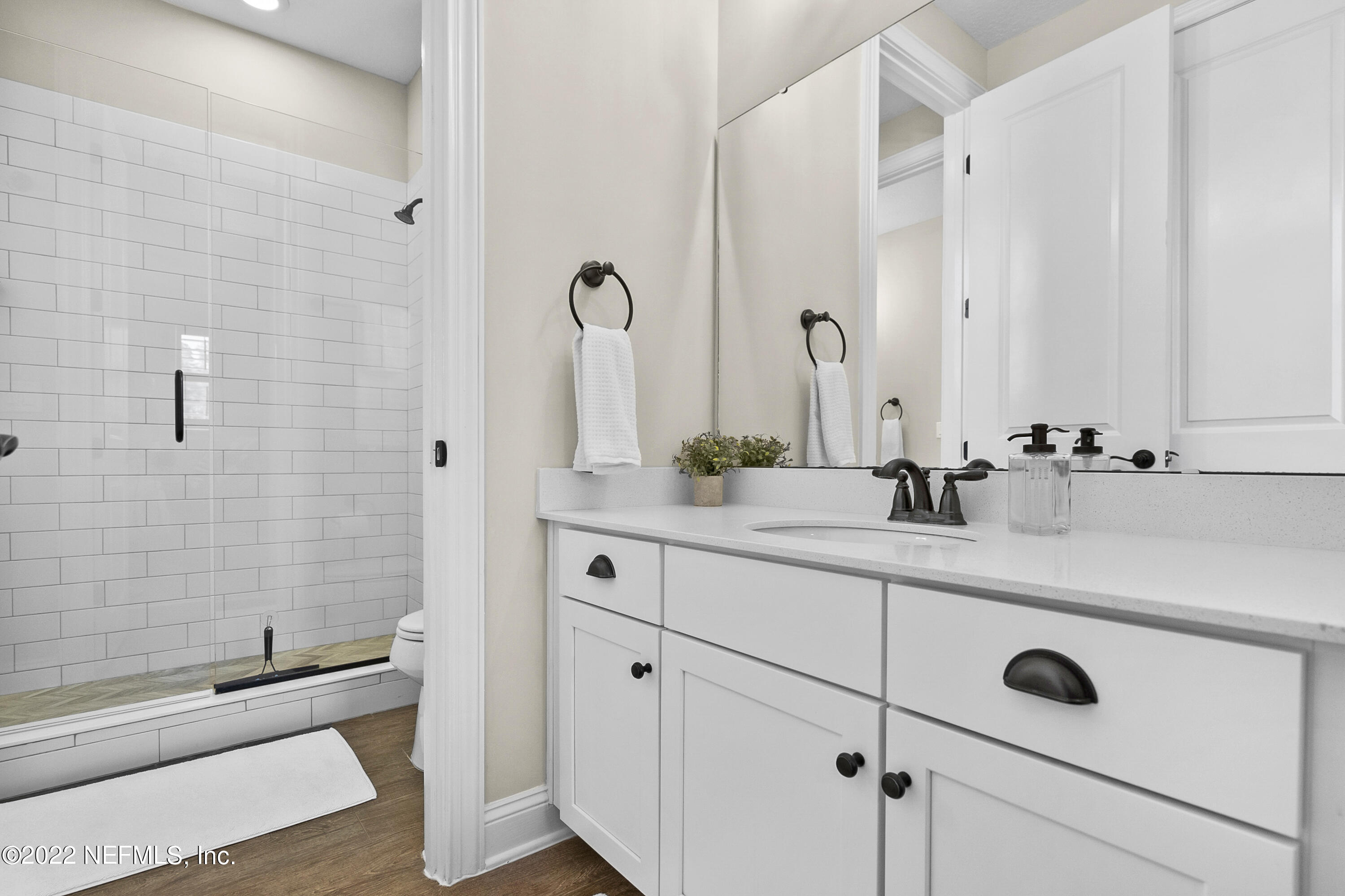 126 Broadleaf Lane St. Johns, FL 32259 - Photo 43 of 70 a bathroom with a double vanity sink a mirror and a bathtub