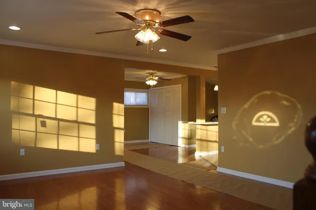 a view of empty room with a window and chandelier
