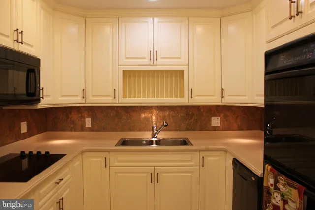 a kitchen with stainless steel appliances granite countertop a sink a stove and cabinets