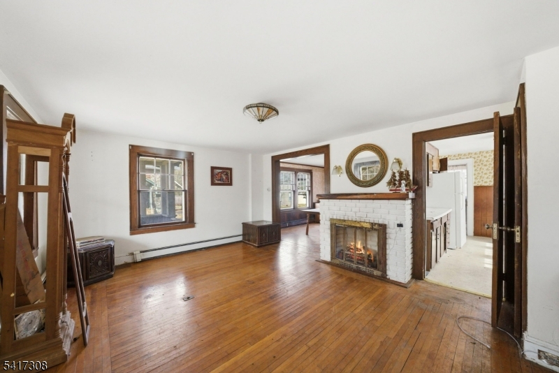 610 Watchung Road Bound Brook, NJ 08805 - Photo 18 of 45 a living room with furniture a fireplace and a flat screen tv