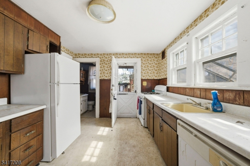 610 Watchung Road Bound Brook, NJ 08805 - Photo 22 of 45 a kitchen with a refrigerator and a sink