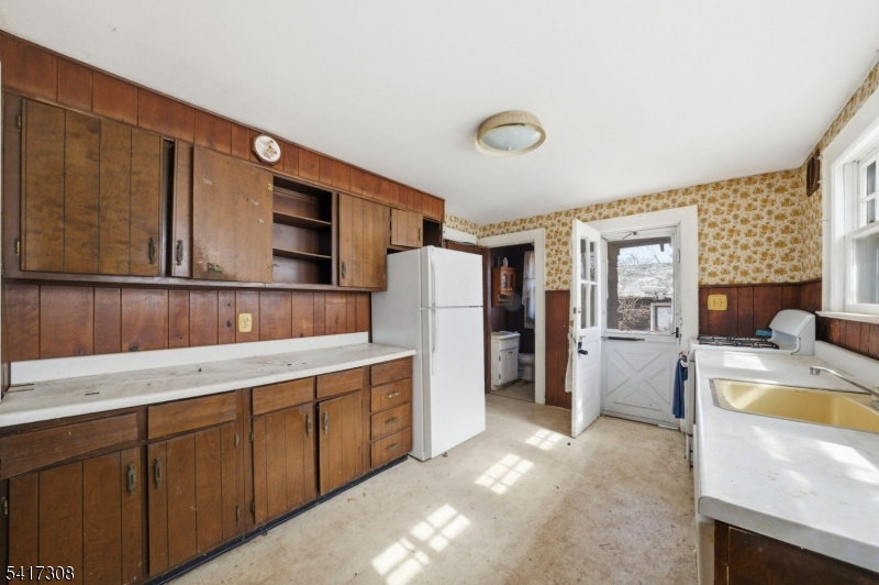 610 Watchung Road Bound Brook, NJ 08805 - Photo 23 of 45 a living room with stainless steel appliances kitchen island granite countertop a refrigerator a stove and a sink with large cabinets