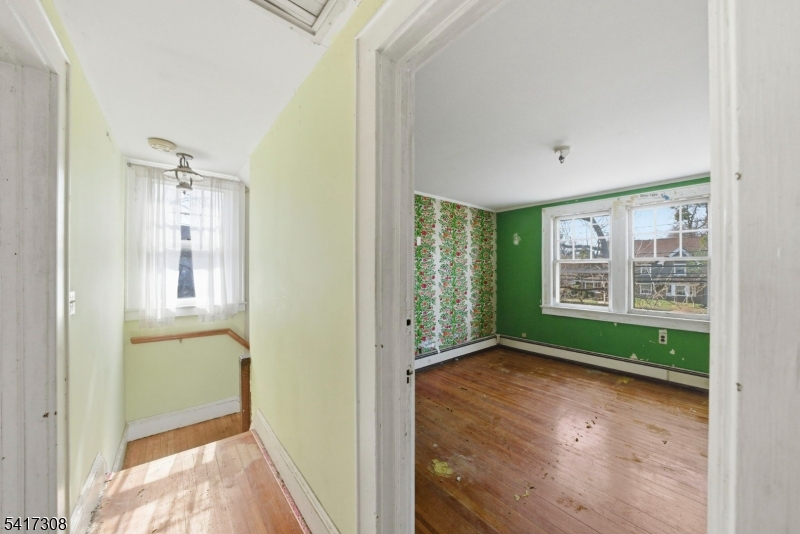 610 Watchung Road Bound Brook, NJ 08805 - Photo 6 of 45 a view of hallway with window and wooden floor
