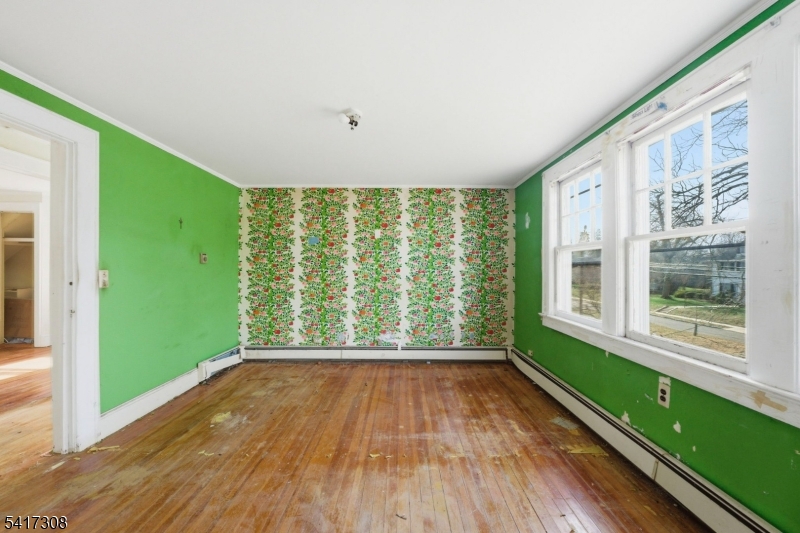 610 Watchung Road Bound Brook, NJ 08805 - Photo 9 of 45 a view of an empty room with a window and wooden floor