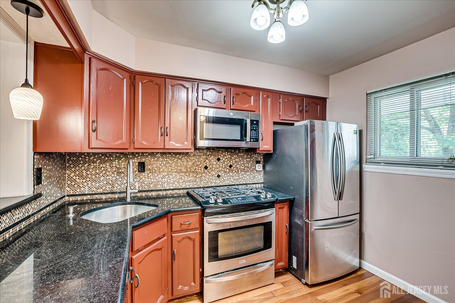 6 Tulip Court Edison, NJ 08820 - Photo 12 of 46 a kitchen with stainless steel appliances granite countertop a refrigerator stove and sink