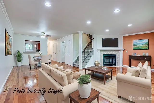an empty room with wooden floor and fireplace