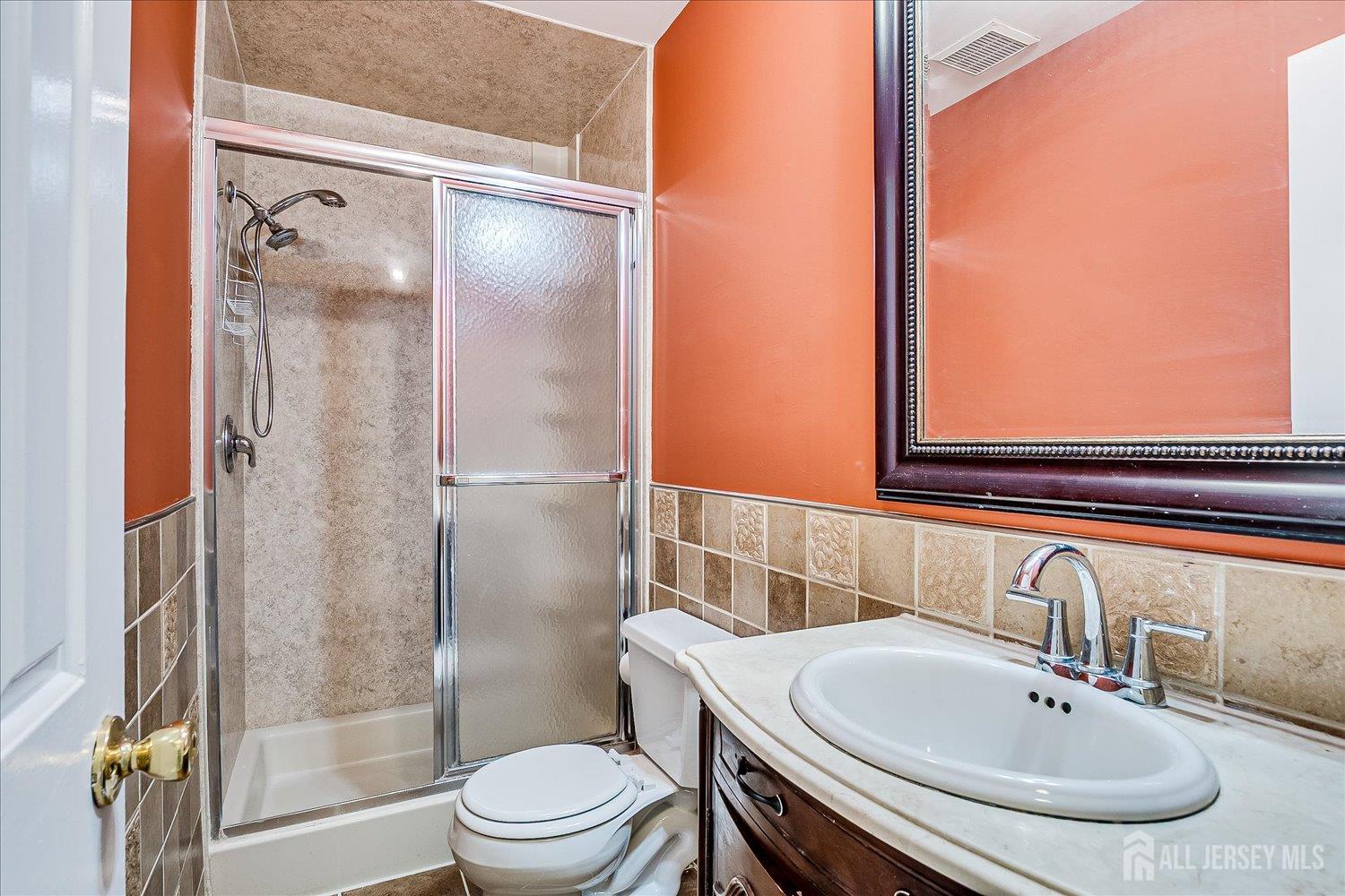 6 Tulip Court Edison, NJ 08820 - Photo 27 of 46 a bathroom with a sink and a mirror