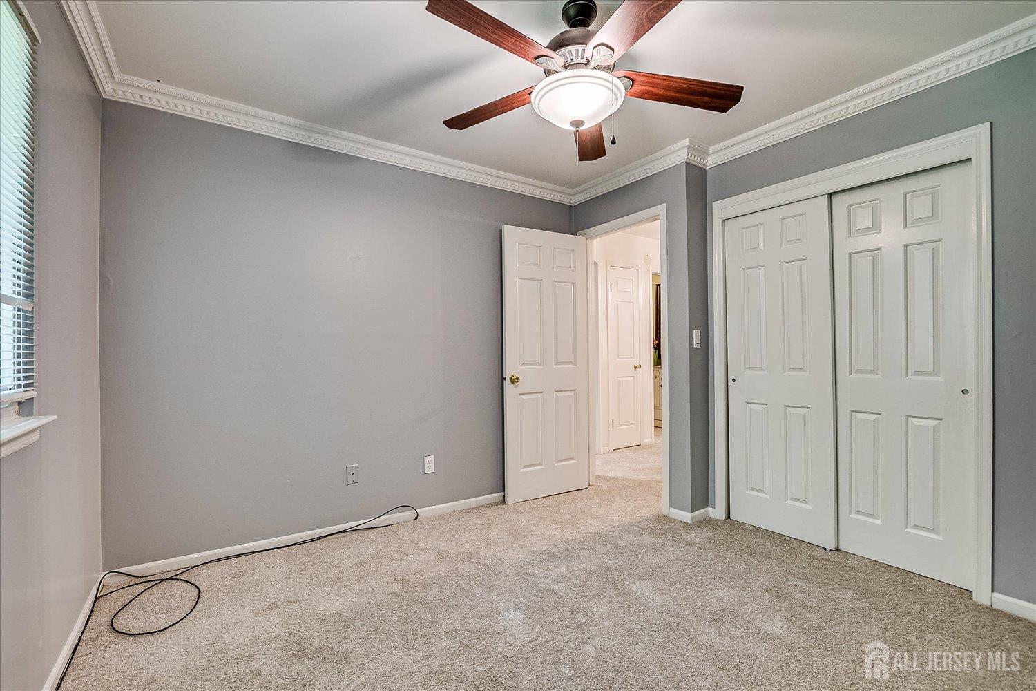 6 Tulip Court Edison, NJ 08820 - Photo 31 of 46 an empty room with chandelier fan and windows