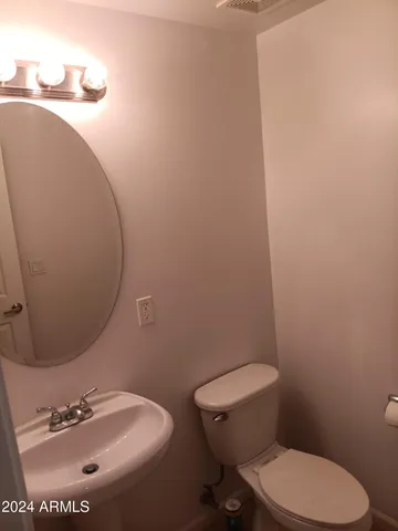 a white toilet sitting next to a bathroom sink