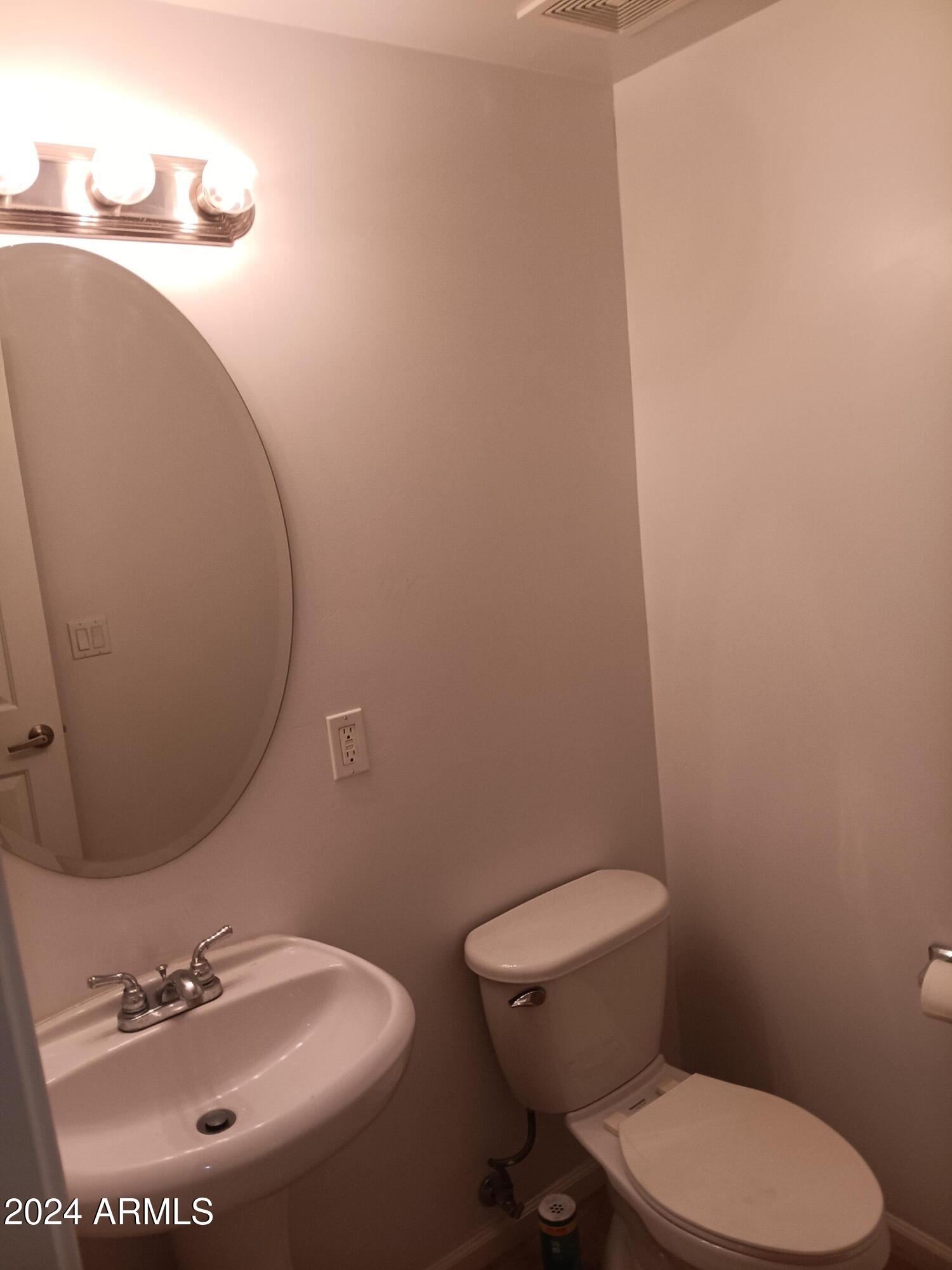 1920 East Bell Road, Unit 1103 Phoenix, AZ 85022 - Photo 13 of 29 a white toilet sitting next to a bathroom sink