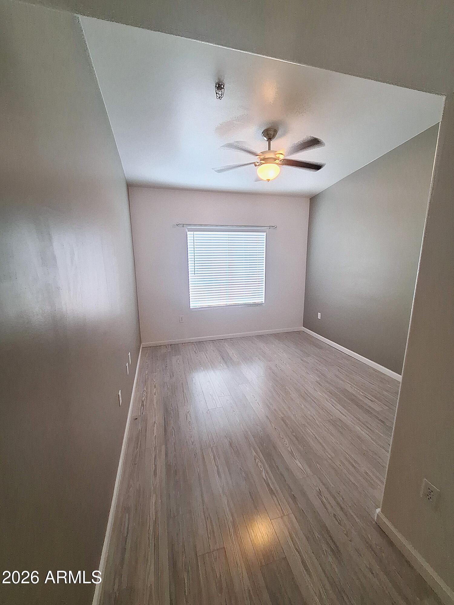 1920 East Bell Road, Unit 1103 Phoenix, AZ 85022 - Photo 18 of 29 wooden floor in an empty room with a window