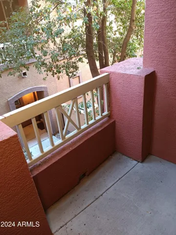 a balcony with view of an outdoor space