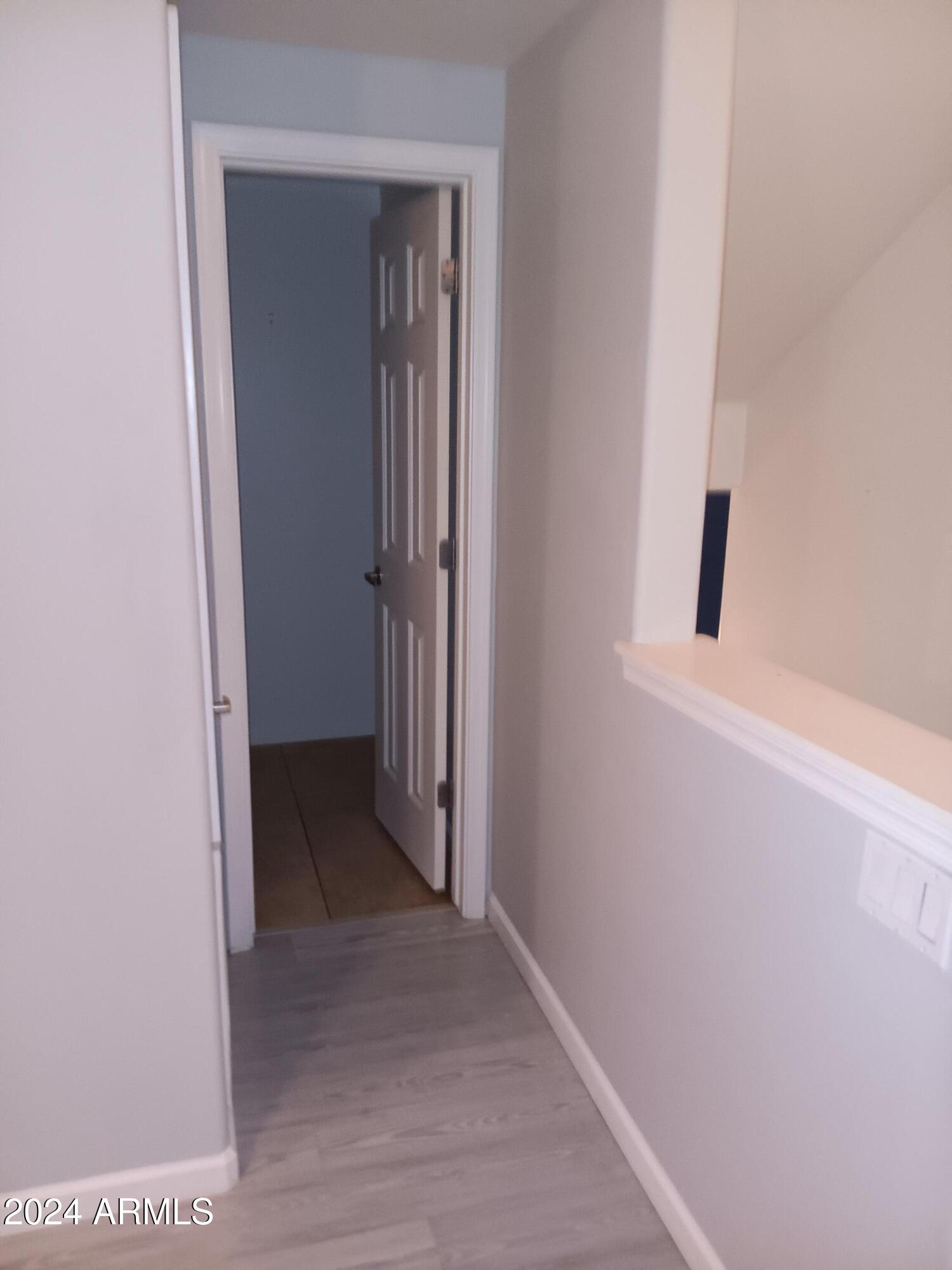 1920 East Bell Road, Unit 1103 Phoenix, AZ 85022 - Photo 5 of 29 a view of a hallway with wooden floor