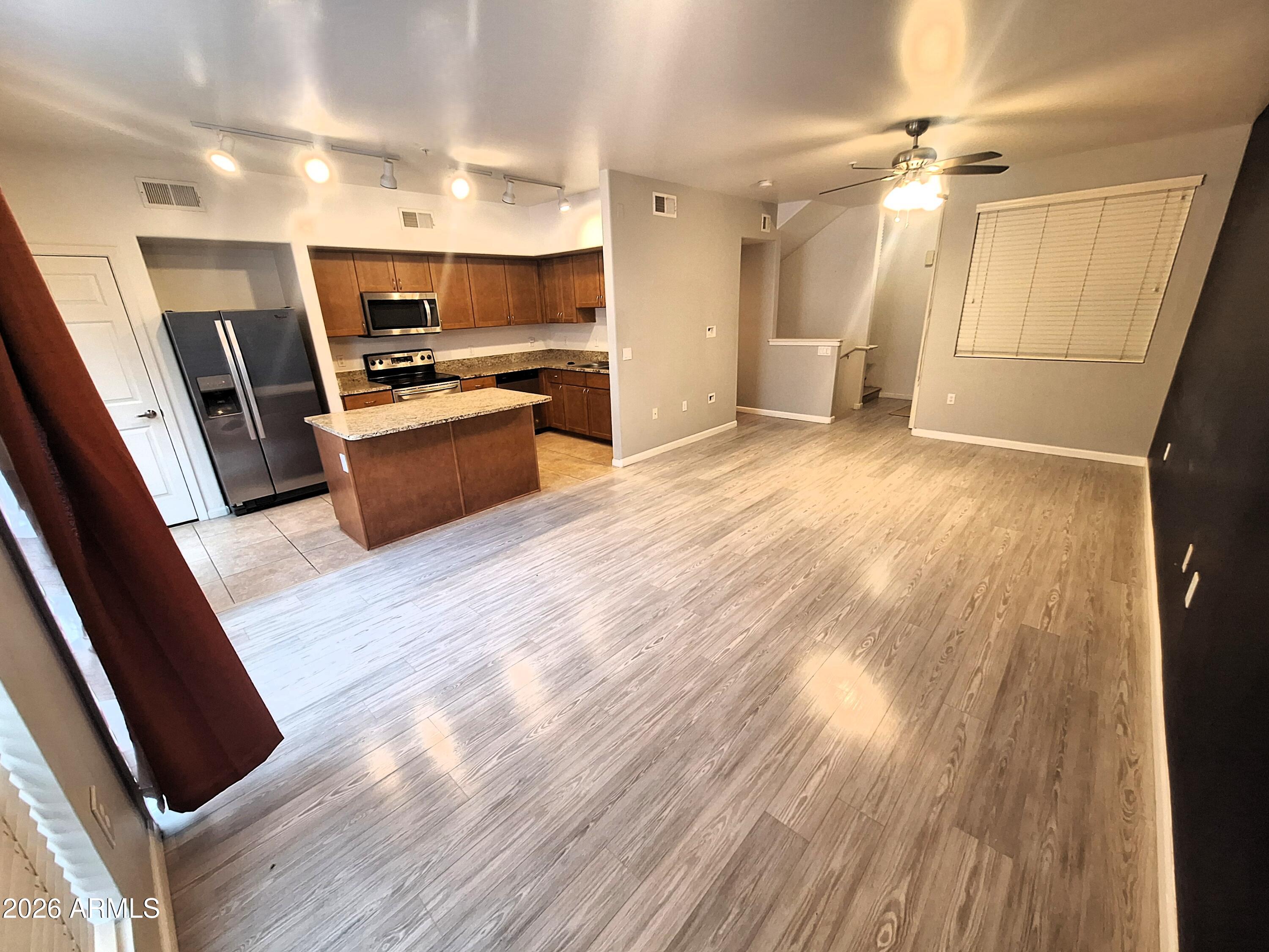 1920 East Bell Road, Unit 1103 Phoenix, AZ 85022 - Photo 6 of 29 a kitchen with stainless steel appliances a refrigerator a sink dishwasher and a stove top oven