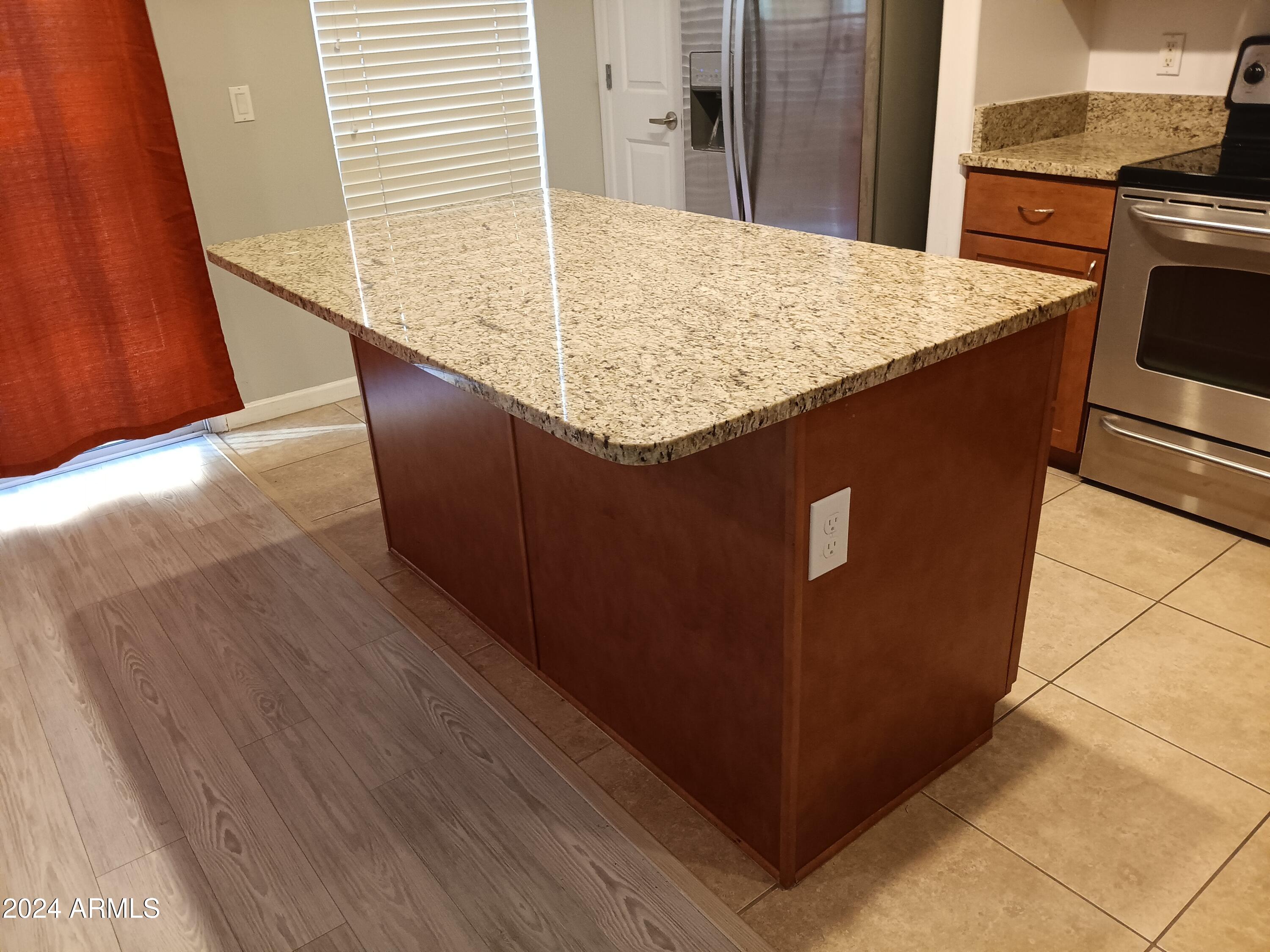 1920 East Bell Road, Unit 1103 Phoenix, AZ 85022 - Photo 10 of 29 a kitchen with kitchen island sink and stove