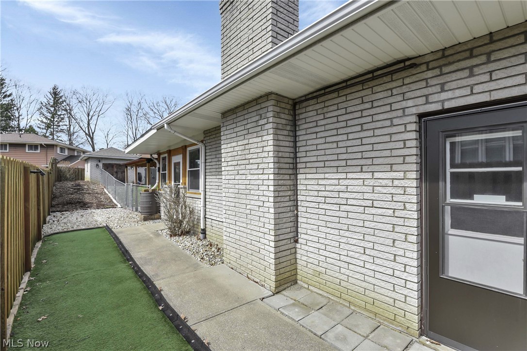 7350 Ames Road Parma, OH 44130 - Photo 42 of 50 Side yard dog run, walkway and entry to garage