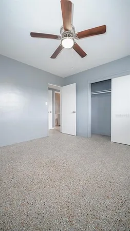 a view of an empty room with a ceiling fan