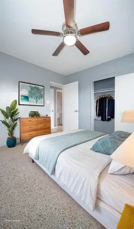a bedroom with a large bed and a chandelier