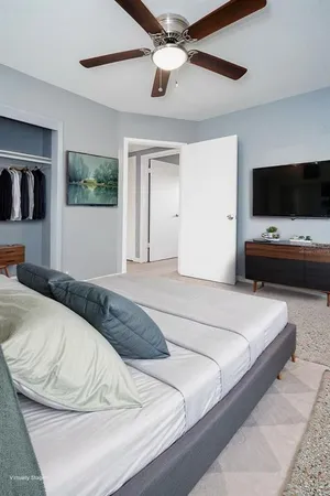 a bedroom with a bed and a flat screen tv