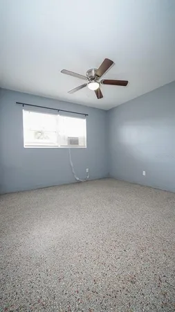 an empty room with a empty space and a ceiling fan