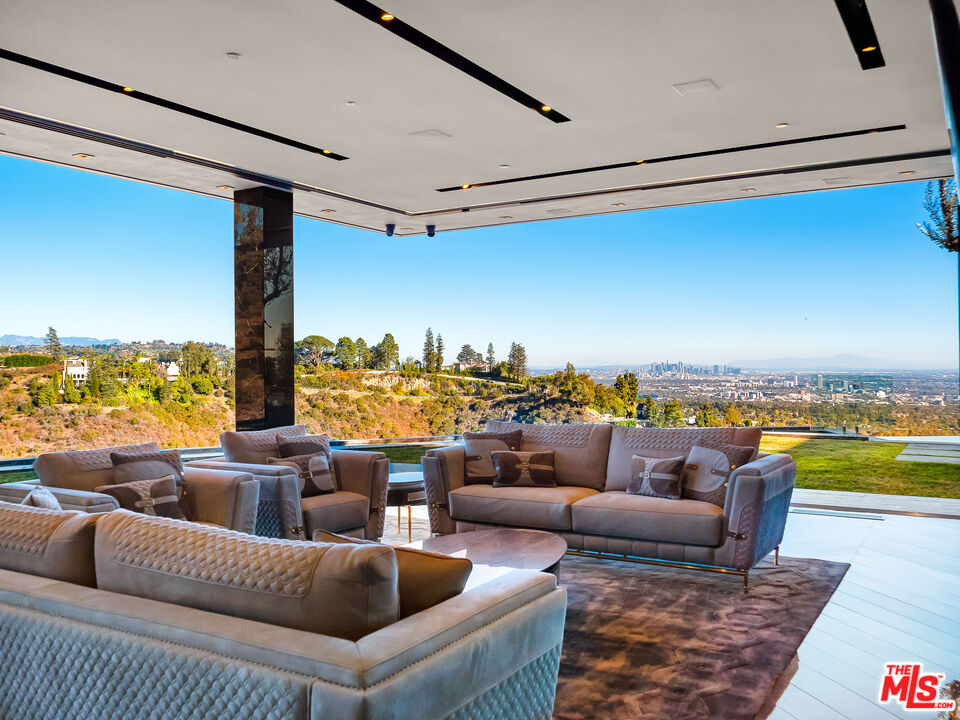 1200 Bel Air Road Los Angeles, CA 90077 - Photo 13 of 27 a living room with furniture and a floor to ceiling window
