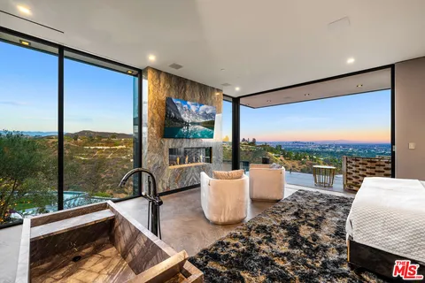 a view of a patio with table and chairs and potted plants